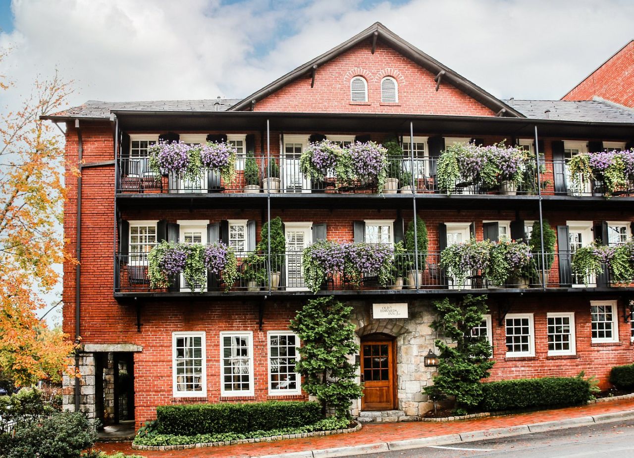 facade of building with balcony and hanging plants